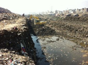 <p>Excavator digging out the river where garbages piled up for years (Image by Ramesh Bhusal)</p>