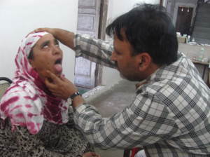 A doctor examining a patient at a free medical camp