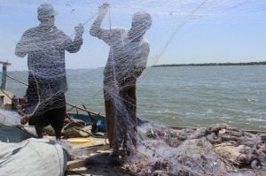 Karachi fishermen holding a net