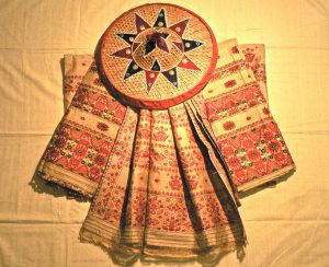 <p>A set of mekhela chadors made with Assamese muga silk arranged around a japi [image by Satnath]</p>