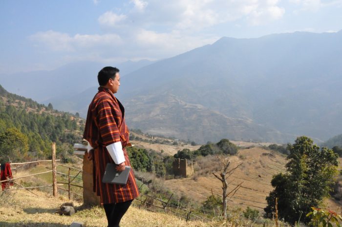 man overlooking dry fields in Bhutan