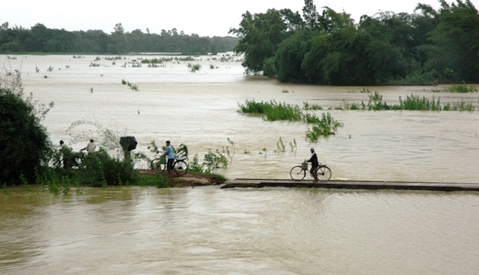 <p>People fleeing the Brahmaputra floods on foot and by cycle [image by Kshitiz Anand]</p>