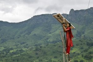 <p>Meenakshi Dewan doing maintenance work on a solar street lighting in her village of Tinginaput, India [image by Abbie Trayler-Smith / Panos Pictures / Department for International Development]</p>