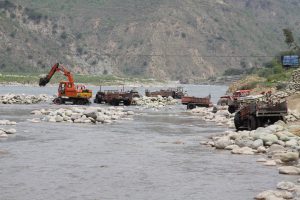 Riverbed mining using heavy machinery destroying habitats