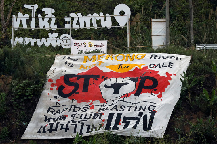<p> A protest banner against rapids blasting in the Mekong River at the border between Laos and Thailand [image by: Jorge Silva/Reuters] </p>