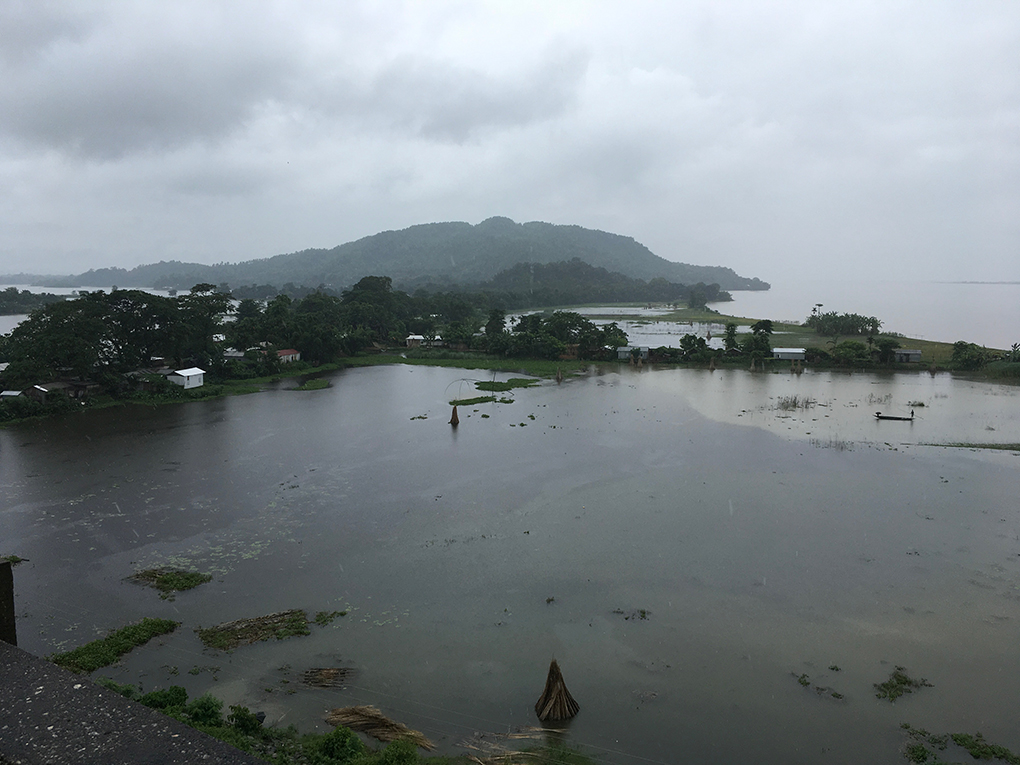 <p>The Brahmaputra (in the background) overflows its banks near Dhubri in Lower Assam during the August 2017 flood [Image by Sucharita Sen]</p>