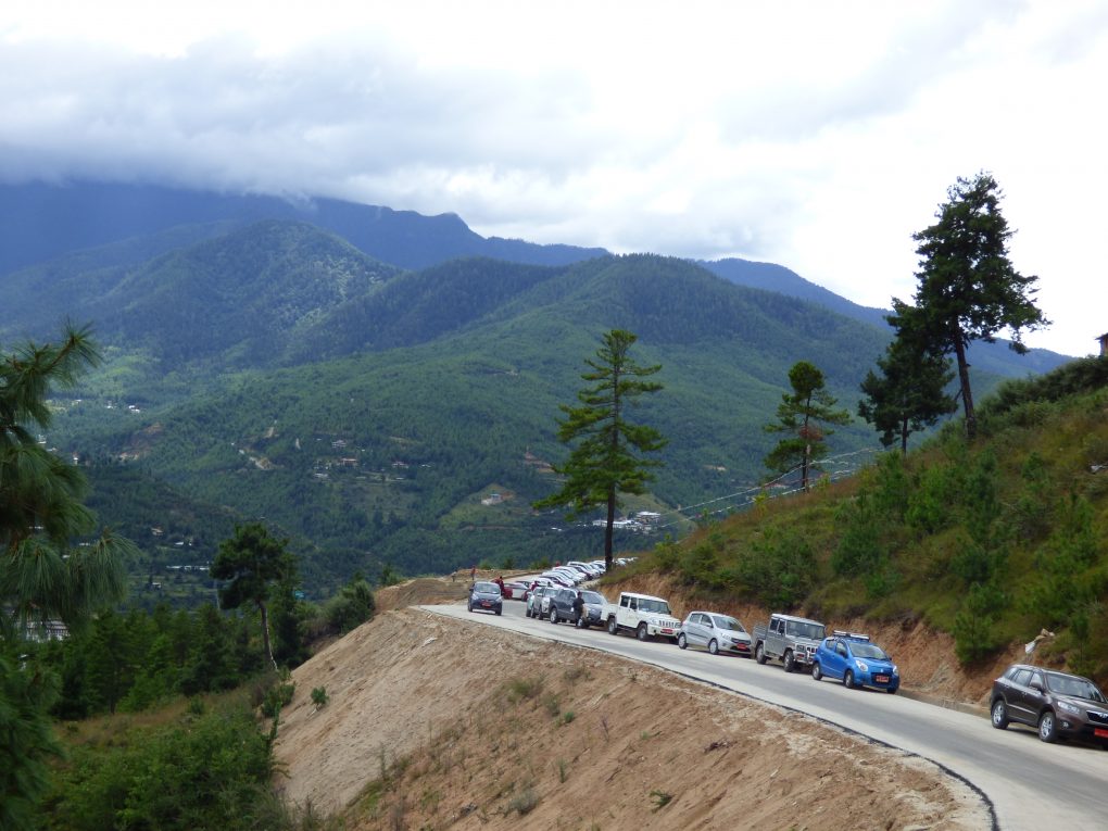 <p>Vehicles lined up near the newly-completed Giant Buddha stupa in Thimphu, Bhutan [Image: Dawa Gyelmo]</p>
