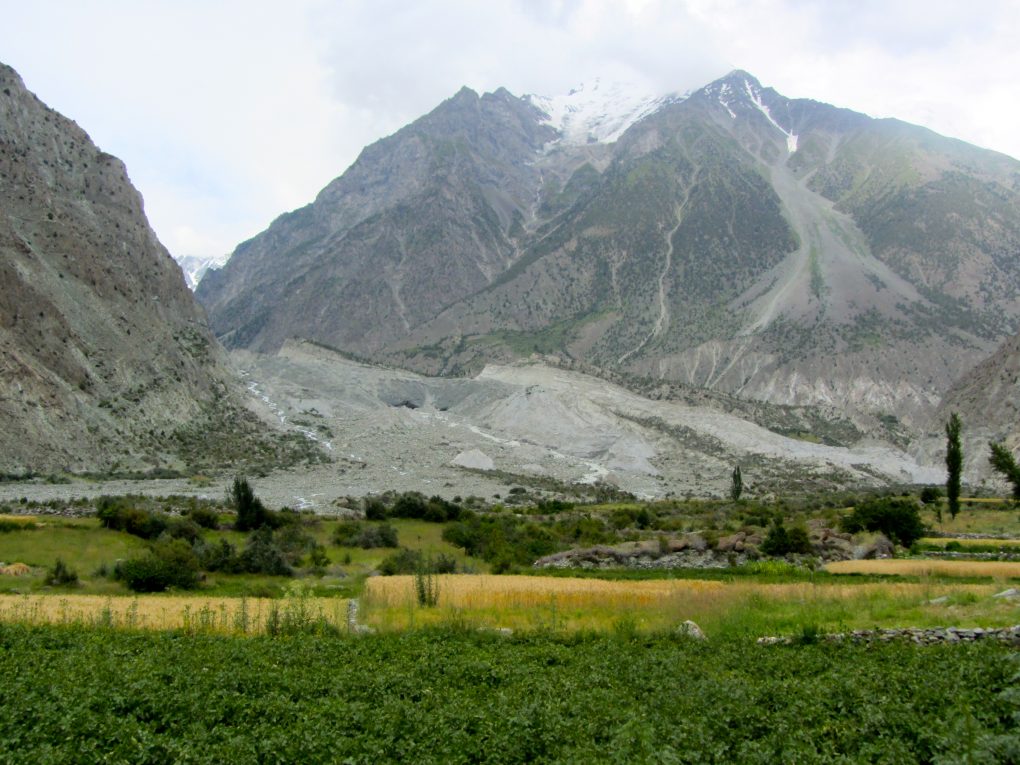 <p>The Hinarchi glacier perches above a village in Bagrote Valley [image by: Rina Saeed Khan]</p>