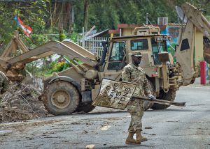 <p>PFC Raiquan Wade, of the South Carolina National Guard, clearing debris in Puerto Rico after Hurricane Maria [image by: The National Guard/SSG Mark Scovell]</p>