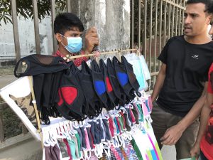 <p>Hawkers have seen the sale of air pollution masks as another thing to add to their inventory [image by: Kamran Reza Chowdhury]</p>