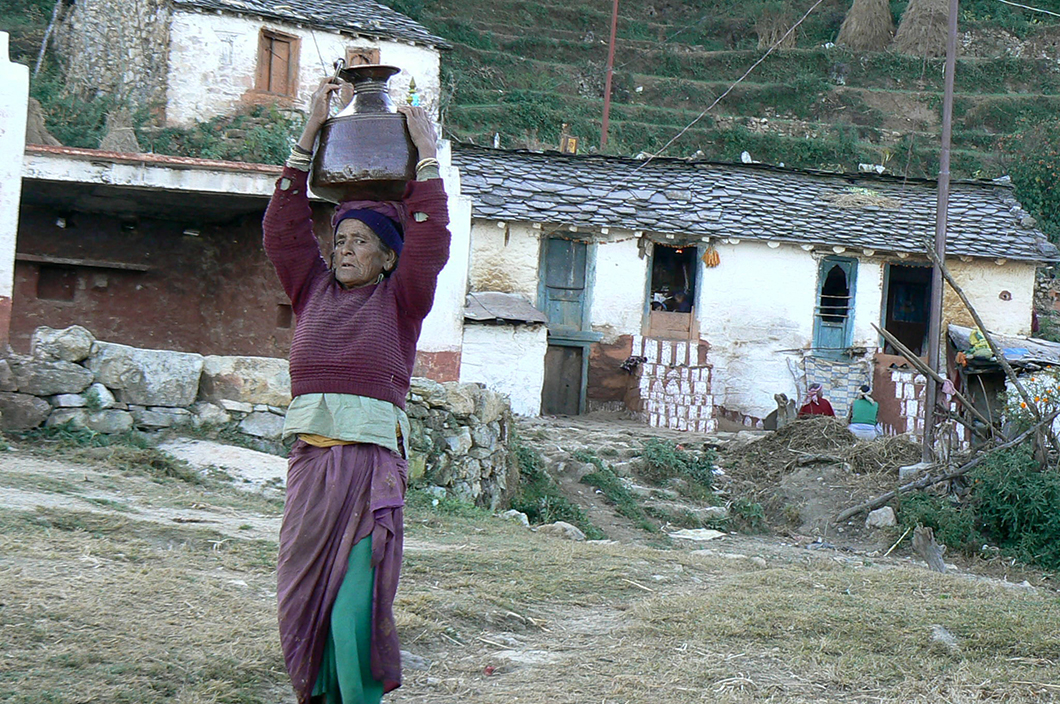 <p>In the Himalayas, most women have to walk miles on hilly terrain to fetch water as local water sources are depleting [Image by Hridayesh Joshi]</p>