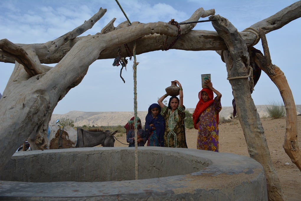 Young girls at a dug well in a remote village near Thano Bula Khan in Jamshoro Dirsticrt near Karachi. Kohistan is an arid region and suffering with severe droughts for many years [image by: Zulfiqar Kunbhar]