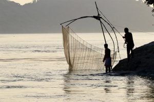 <p>Fishermen on the Brahmaputra, a river that winds through four countries [image by: Sumit Vij]</p>