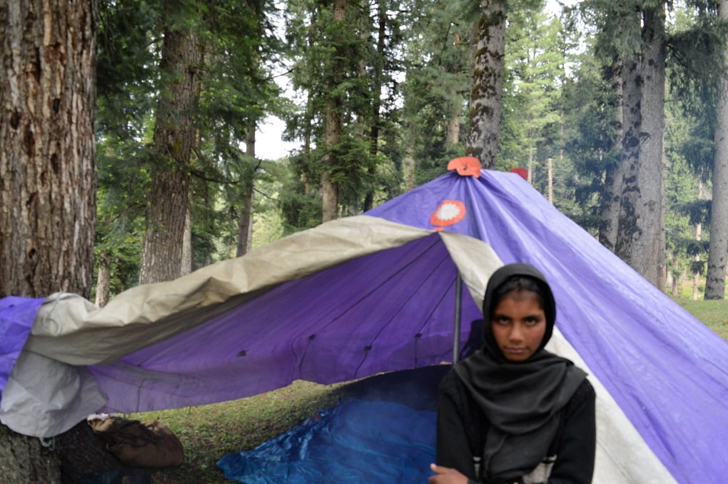 Muneeza standing in front of a tent [image by: Athar Parvaiz]