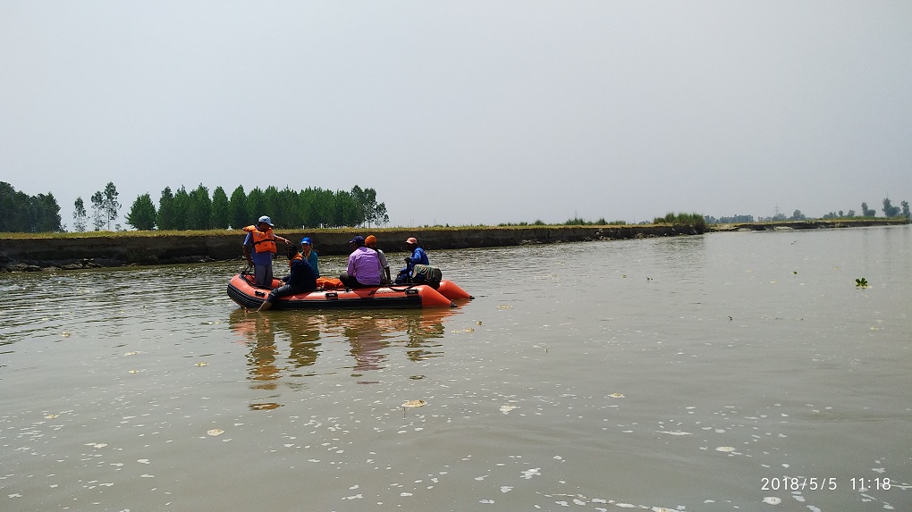 Six men conducting a river survey on a boat