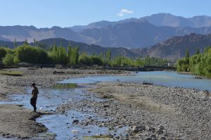 <p>A boy crossing a small channel containing sewage which drains into the Indus near Choglamsar in Leh [image by: Athar Parvaiz]</p>