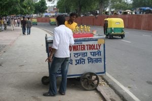 <p>A man selling refrigerated water on Delhi&#8217;s street [image by: Chris Wilson] </p>