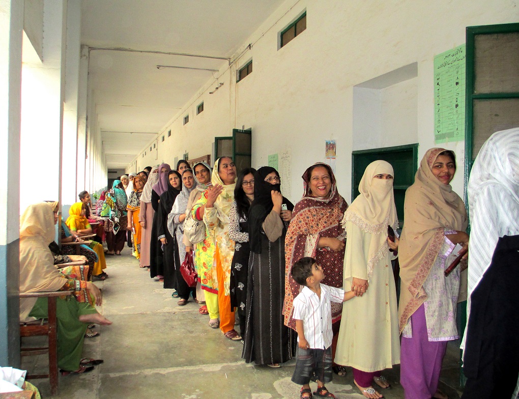 <p>Women in Rawalpindi voting for 2013 general election [image by: Rachel Clayton/Department for International Development]</p>