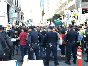 <p>Environmental activists and police face off on the opening day of the GCAS [image by: Joydeep Gupta]</p>