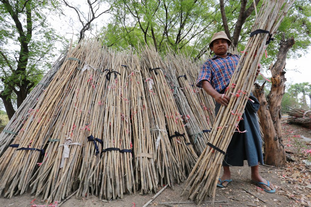 A seller sells bamboo stakes to farmers in Chaung U township