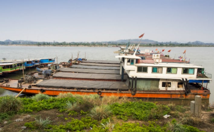 Chinese flagged river boats tied up in the port in Chiang Saen, on the Mekong in Thailand. (Photo: Jack Kurtz)