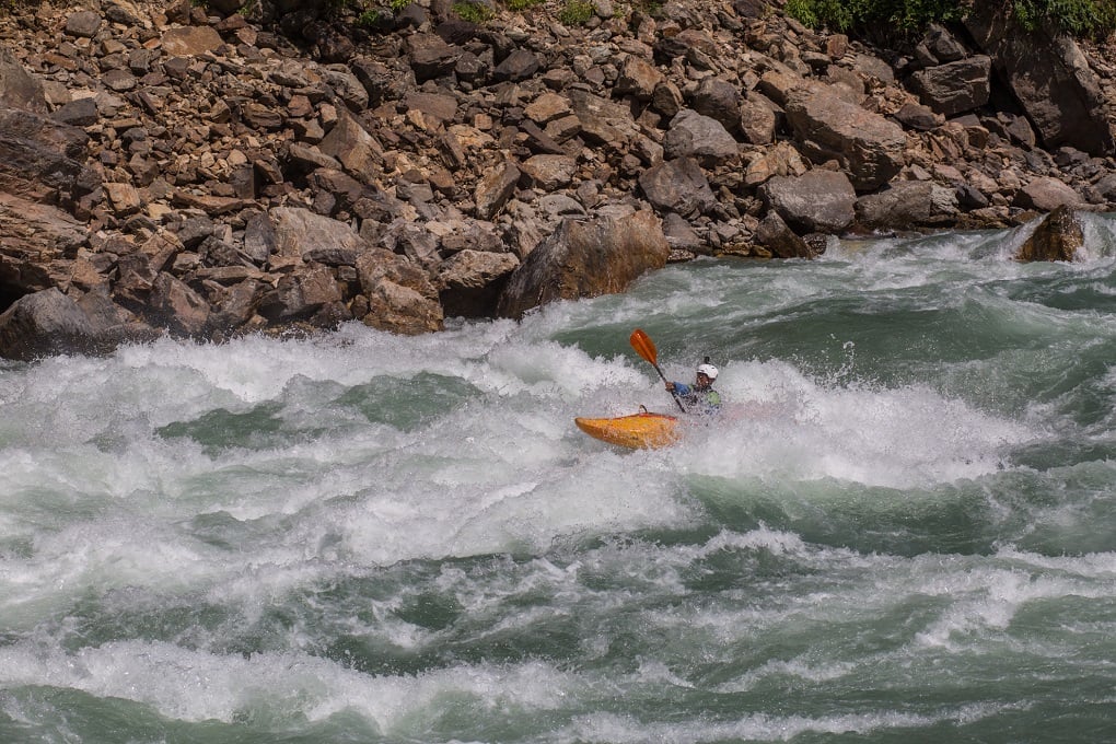 A kayak paddles in the Karnali River in Accham district of Nepal [image by: Nabin Baral]