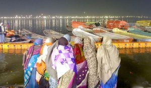 A group of women praying at the confluence of the Ganga