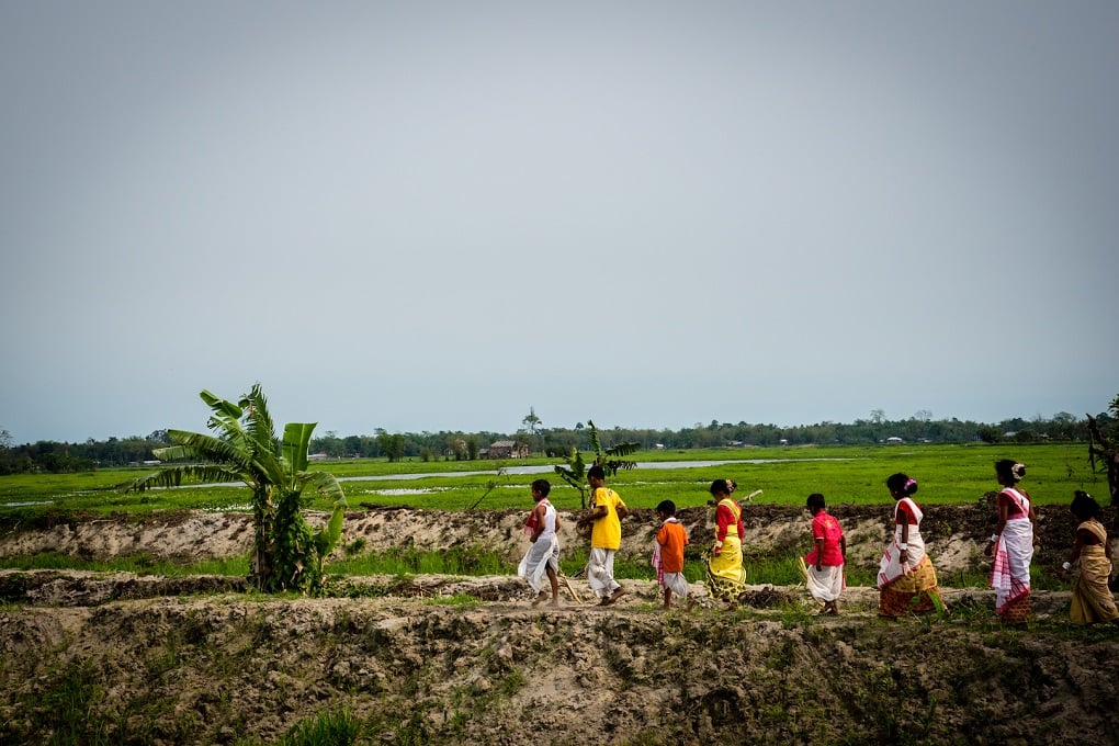 <p>Children crossing the flood-impacted barren paddy fields of North Lakhimpur, on Rongali Bihu day [image by: Shailendra Yashwant]</p>