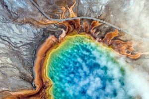 <p>Visitors walk past Grand Prismatic Spring in Yellowstone Park where warming temperatures have brought rapid changes. Winters are shorter. Less snow is falling. Summers are hotter and drier. In a few decades, this iconic American landscape will not be the same. [Credit: Josh Haner/The New York Times]</p>
