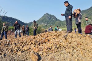 <p> Villagers in Sanhe, Guangx,i stand on suspect farm land (Image: Newscom / Alamy)</p>