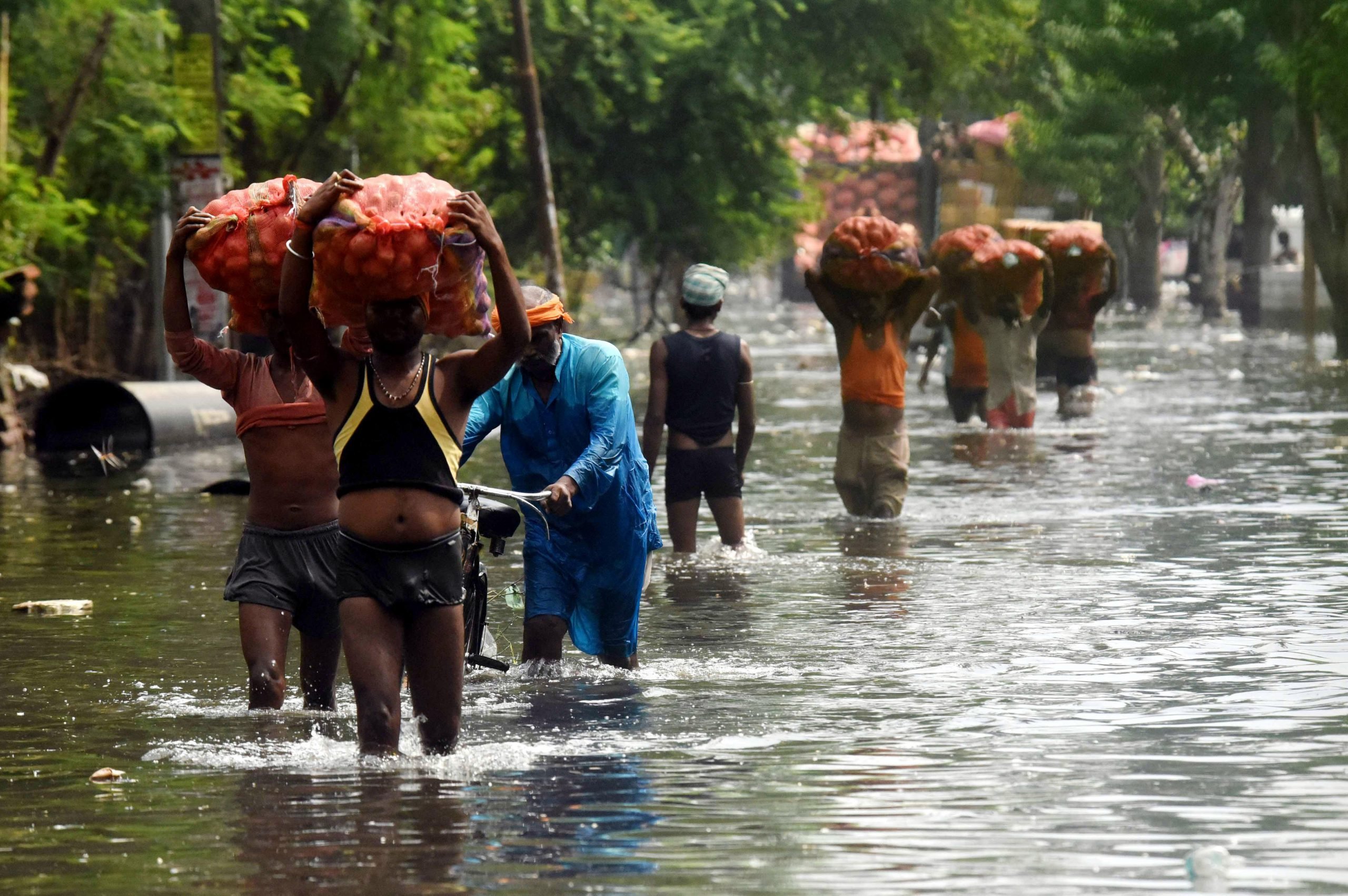 Residents travelling through Patna flood.