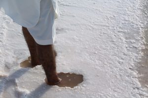 man stands in salt lake Achhro