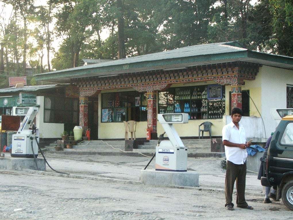 <p>With their ornate woodwork, petrol stations in Bhutan look different, but create the same problems of emissions in a country too dependent on cars [image by: Omair Ahmad]</p>
