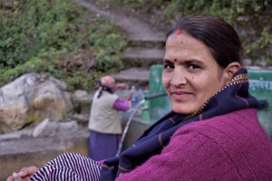 This spring in a village of Nepal’s Darchula district was repaired by the women of India and Nepal working together; women from India cross the Mahakali every day and come to the spring for water; Chandra Samantha sits by [image by: Minket Lepcha]
