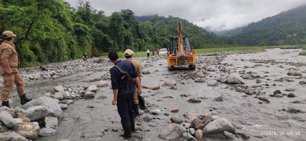 <p>Bhutanese officials overseeing repair work to allow water from Kalanadi to flow into irrigation channels in Assam, India [image by: Tshering Darjey]</p>