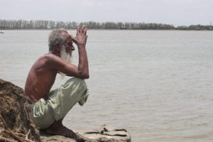 Eighty-year-old Karim Gazi first lost his home in 2009 to Cyclone Aila. He built a new home in Bonnyatola village near the Kholpetua river in the district of Satkhira, south-west Bangladesh. Cyclone Amphan washed away his new home [image by: Inzamamul Haque]