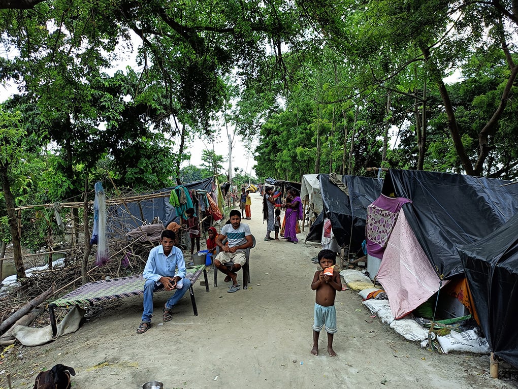 bihar flood victims taking refuge atop another part of embankment
