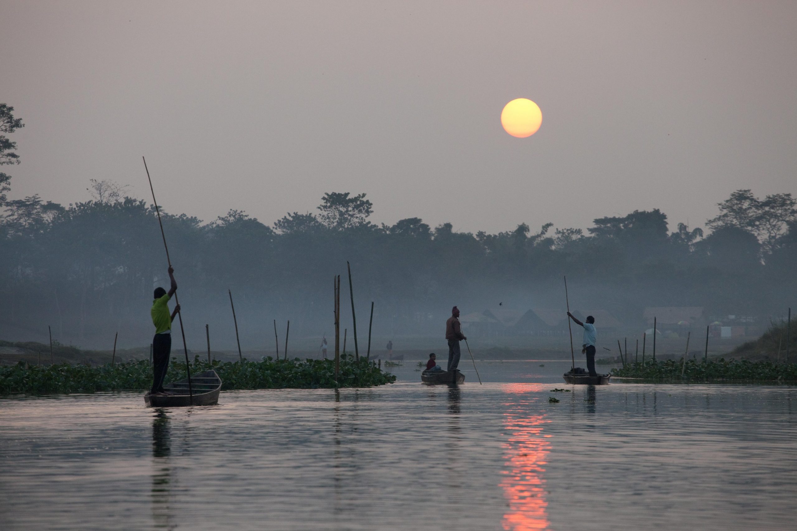 <p>Fishers returning at sunset from the Brahmaputra to their homes inside Dibru Saikhowa National Park [Image by Alamy]</p>