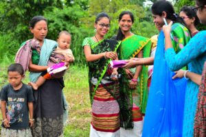 Health workers distributing free sanitary pads to the women and girls in the Indian state of Tripura and explaining to them the necessary of using it, in a health camp. [image by: Abhisek Saha / SOPA Images / ZUMA Wire / Alamy Live News]