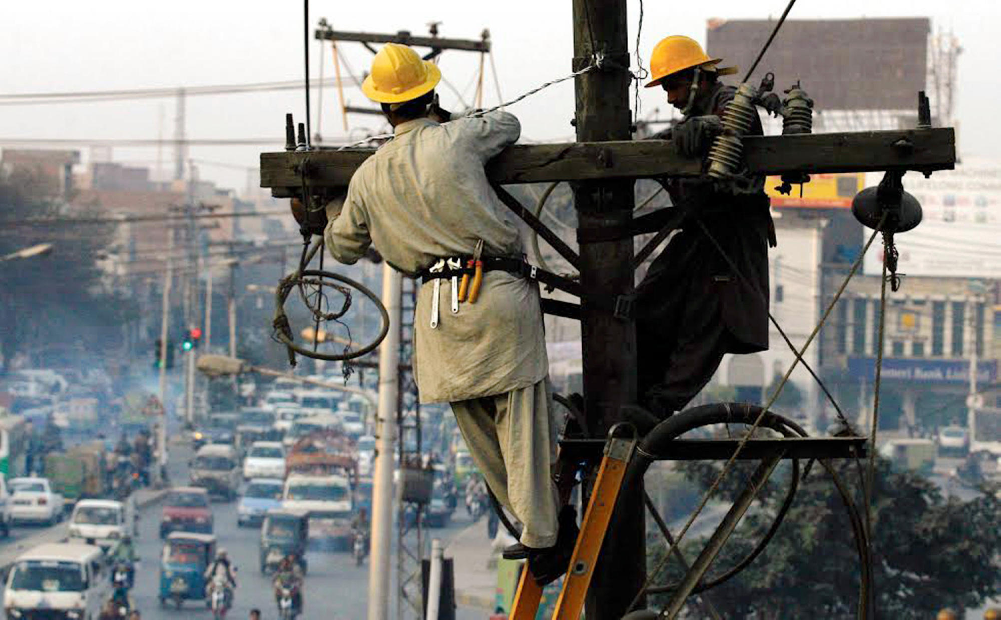 <p> This 2013 photo shows Pakistani technicians fixing an electricity tower in Lahore. Today, the country is in the midst of a debate about the future of its power sector as it confronts huge electricity payments amidst persistent blackouts [Image: Alamy]</p>