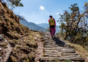 <p>A woman walks on steep mountain paths in the Himalayas of Uttarakhand in northern India [Image: Alamy]</p>