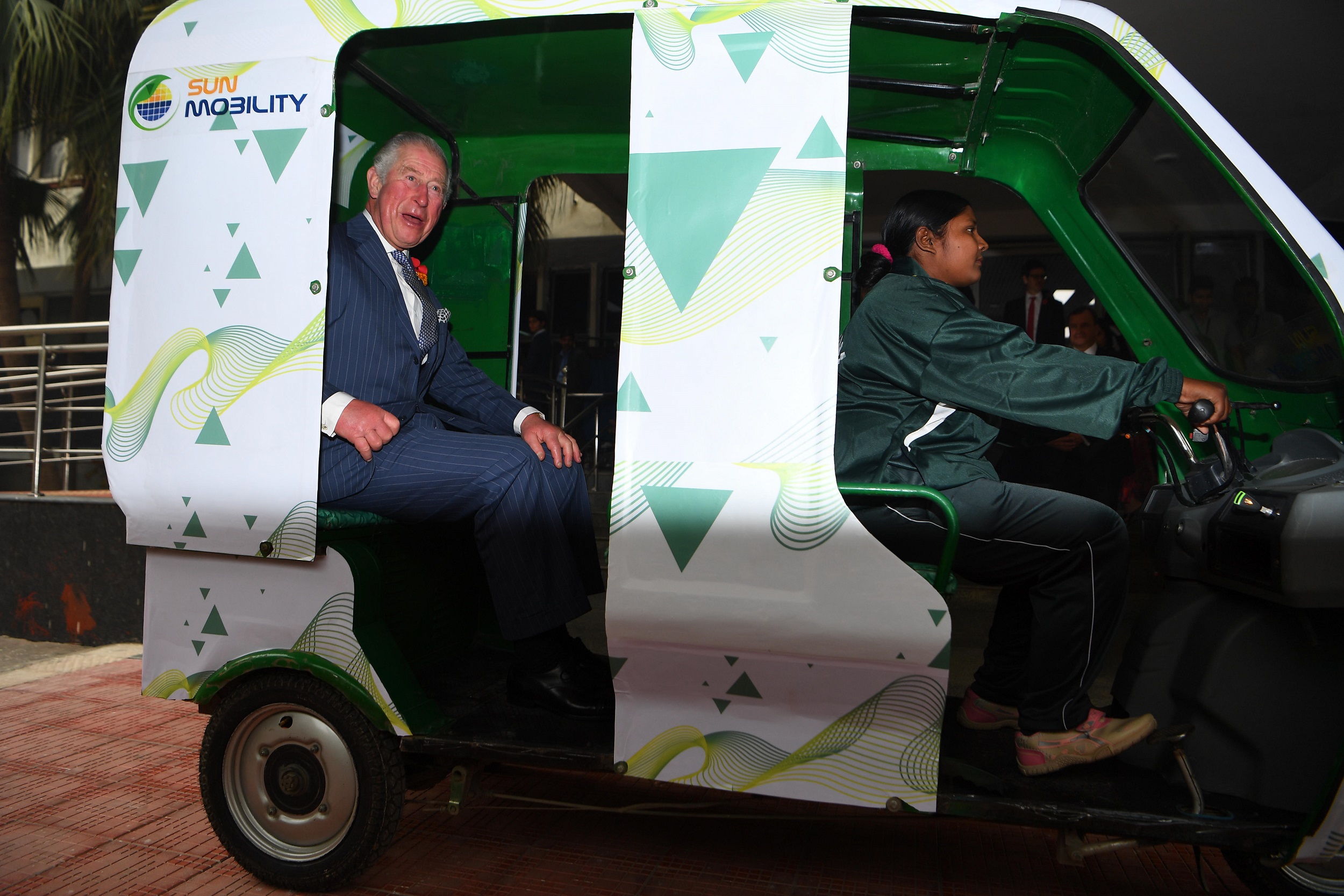 The Prince of Wales is given a demonstration of an e-rickshaw driven by Maria as he visits the Indian MET office in New Delhi [image: PA Images / Alamy]