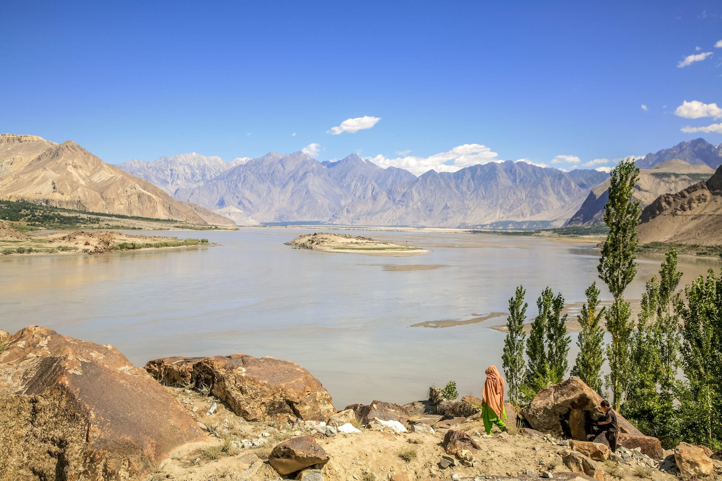 <p>A solitary woman, wearing a traditional headscarf, walks towards the Indus river near Skardu in northern Pakistan (Image: Alamy)</p>