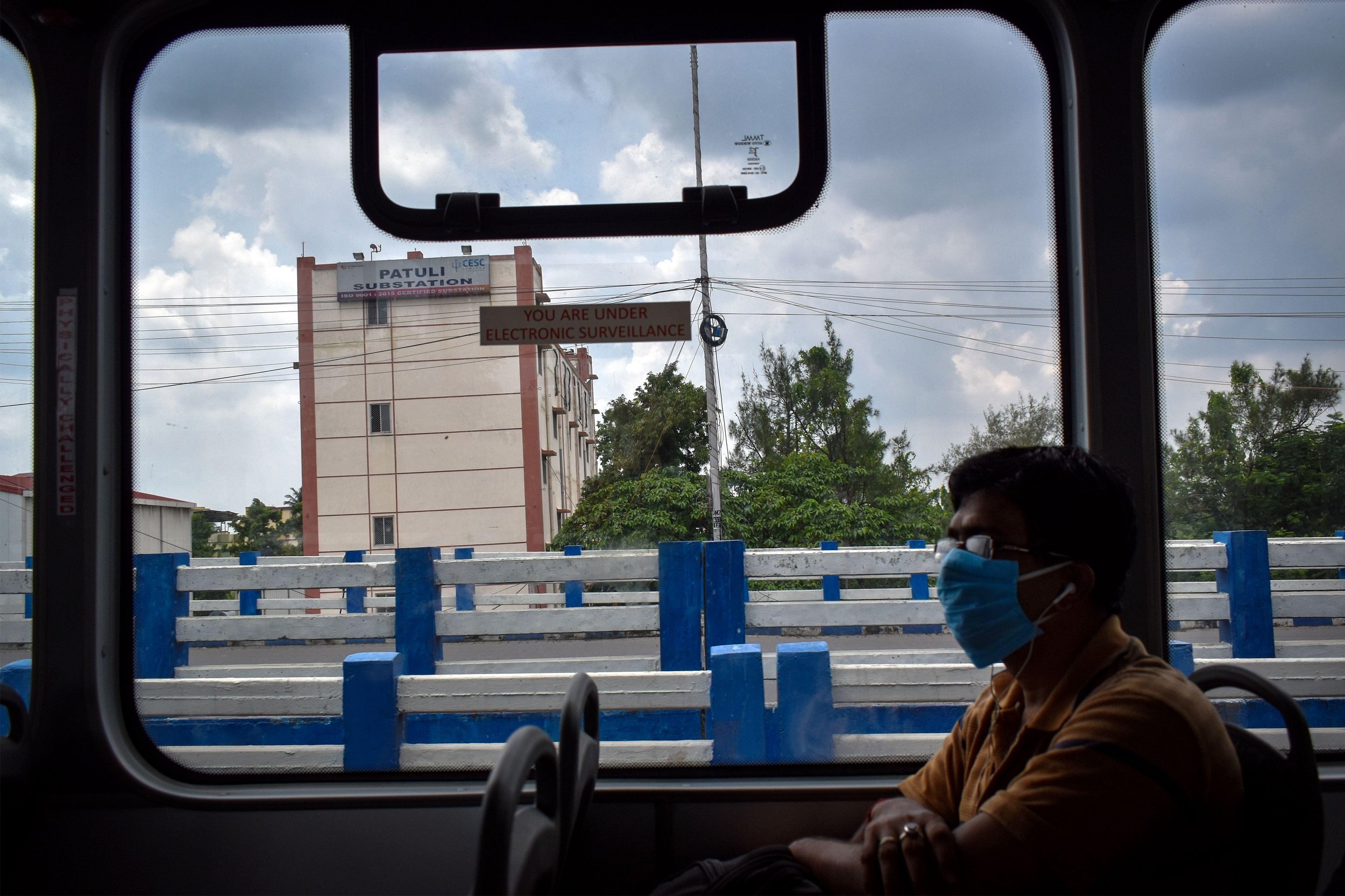 A man wearing a mask and travelling on an electric bus during the Covid-19 pandemic period in Kolkata [image: Sudipta Das / Pacific Press / Alamy Live News]
