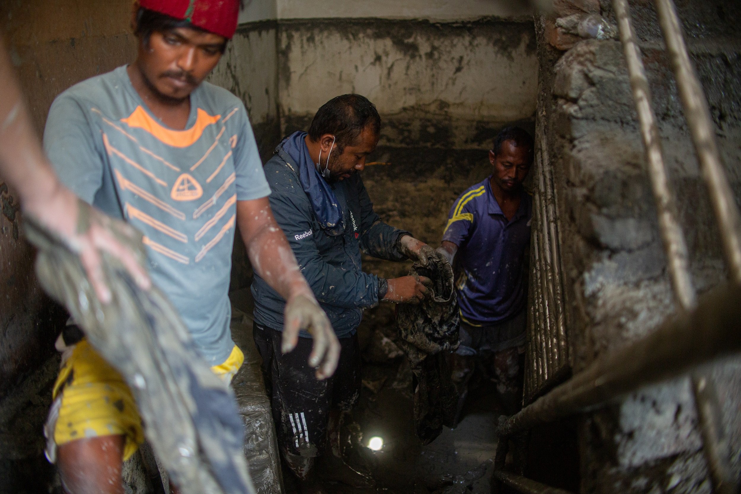 A week after the devastating flood, locals pick up their belongings, coated with mud and debris (Image: Rojan Shrestha)
