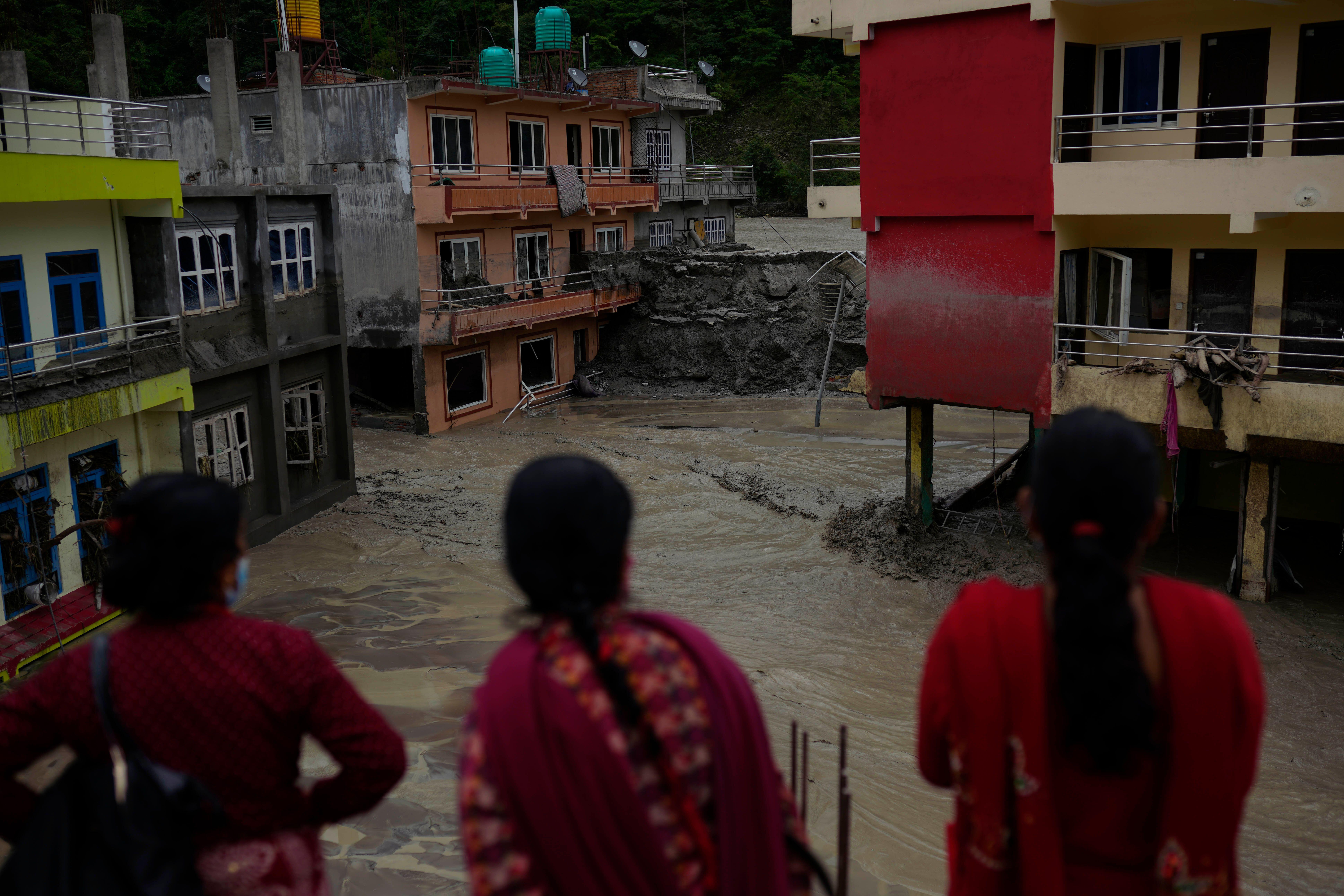 <p>Floodwater from the Melamchi River gushes through houses in Sindhupalchowk district, Nepal. Landslides in the Bhemathang area caused subsequent flooding along the Melamchi River in June 2021. (Image: ZUMA Press, Inc / Alamy)</p>