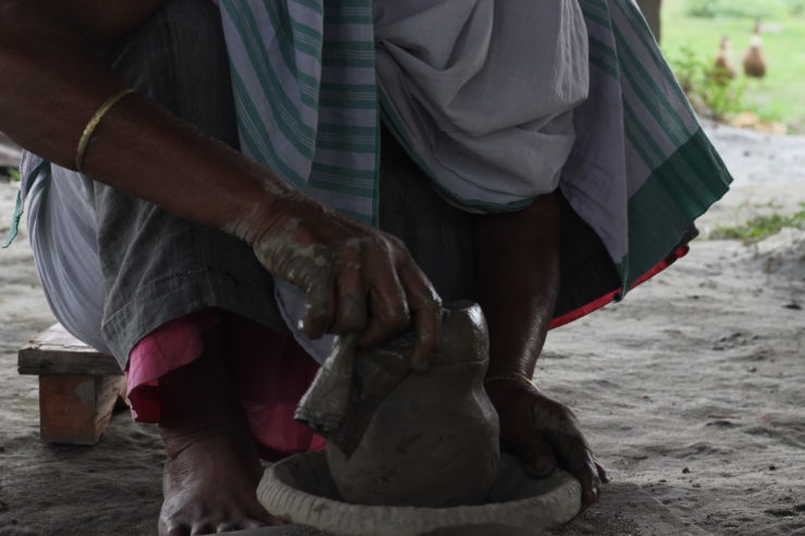 Shaping the clay for a pot to brew apong. Photo: Ashima Sharma