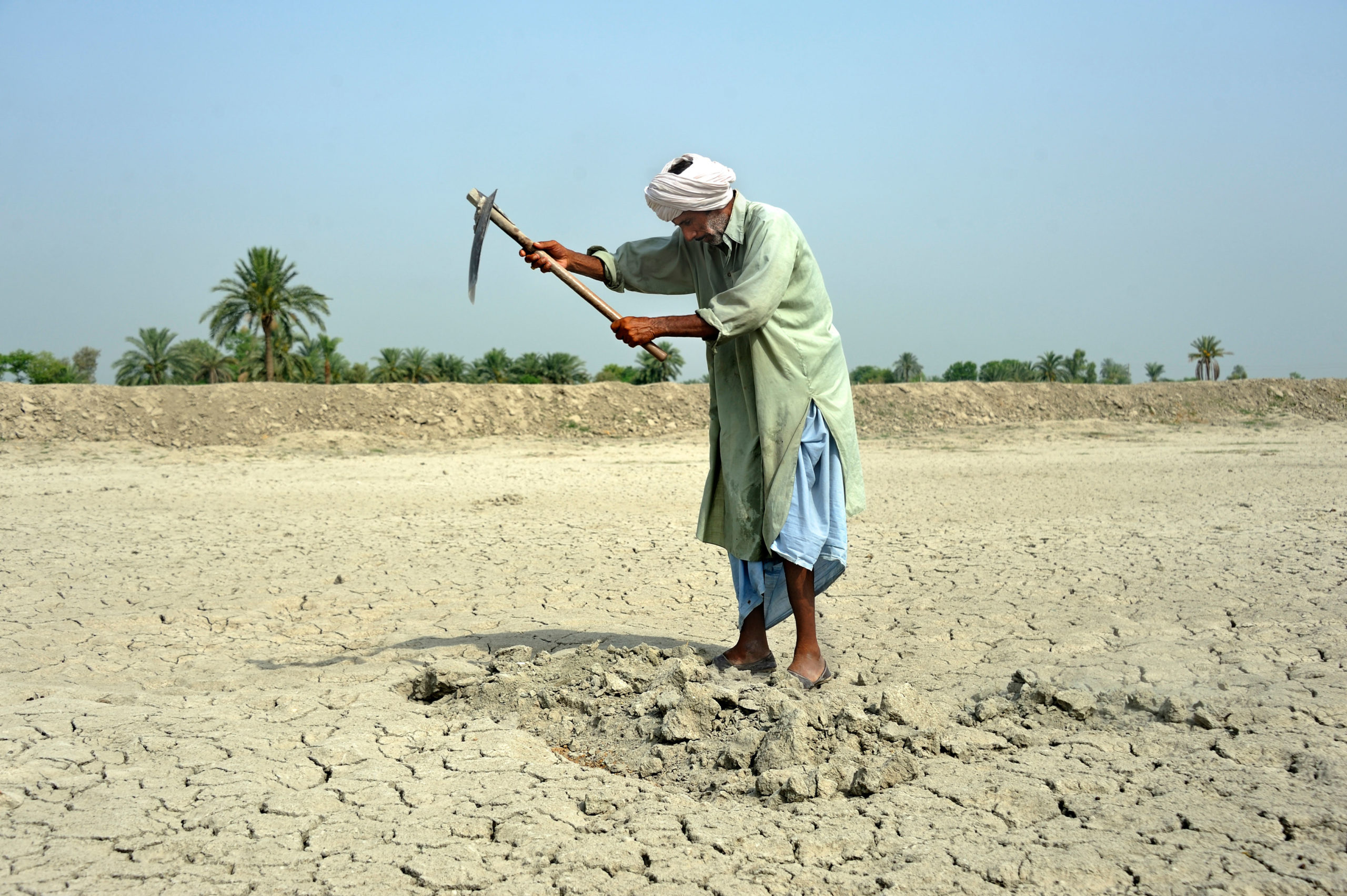 A farmer working on dry soil in Basti Lehar Walla, Pakistan. Climate change is driving more extreme weather, including droughts, in South Asia.