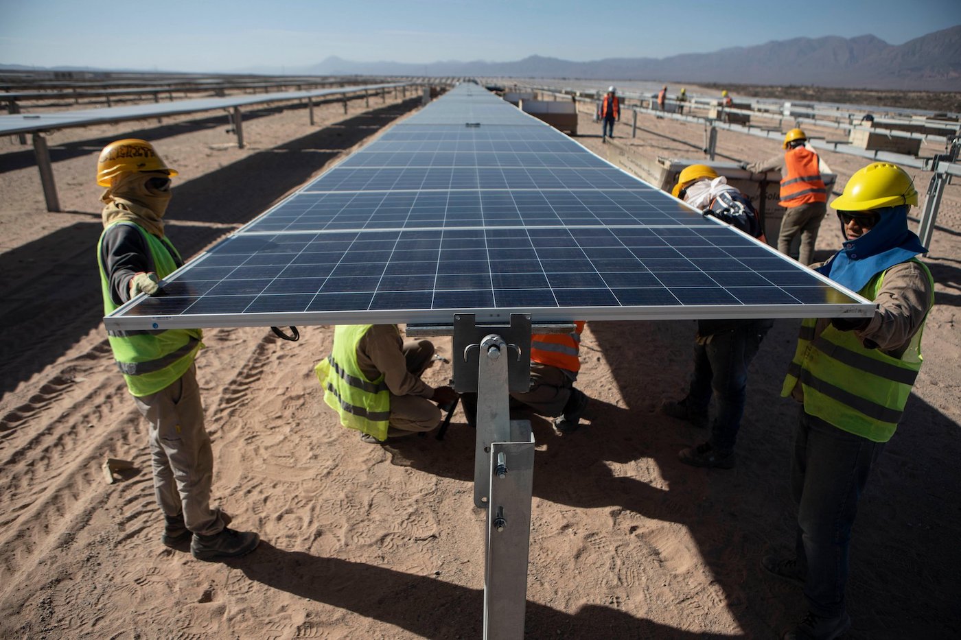 Workers install solar panels at a PowerChina plant in Argentina