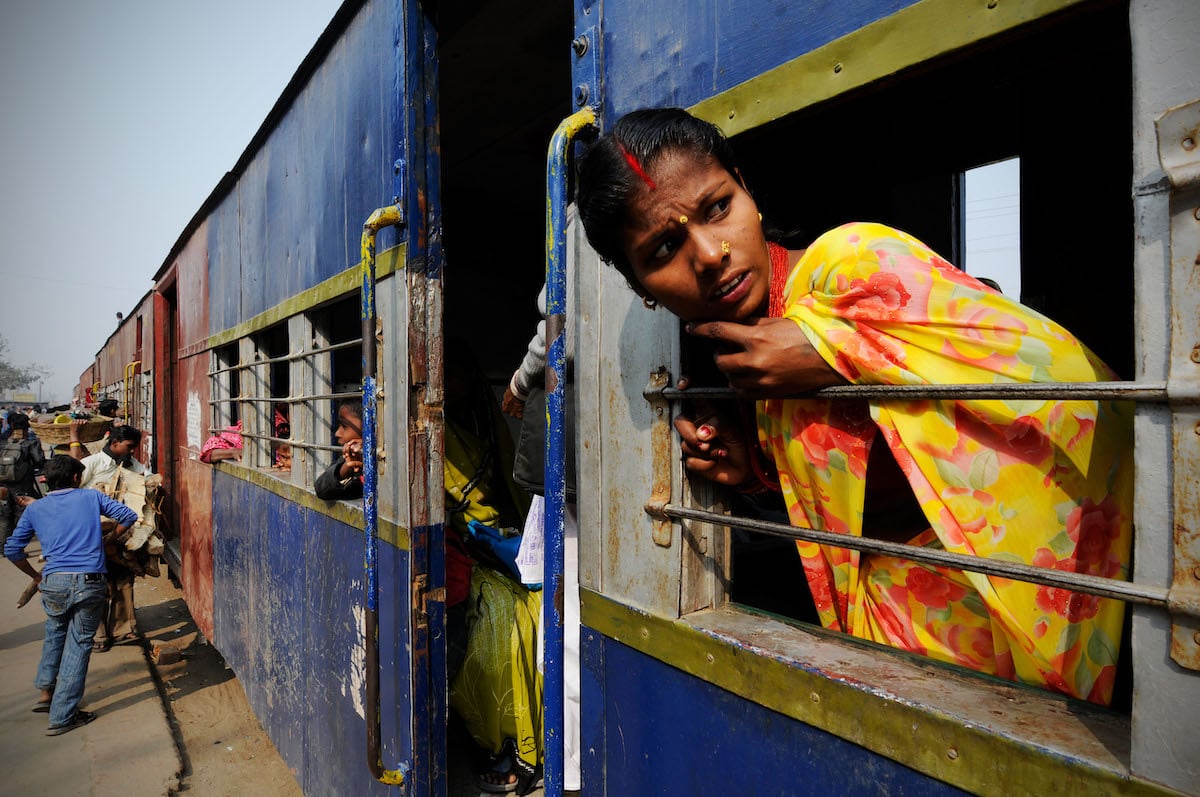 <p>A woman on a train in Janakpur, Nepal. In its updated Nationally Determined Contribution, Nepal pledged to develop 200 kilometres of electric railway network by 2030. (Image: Leonid Plotkin / Alamy)</p>